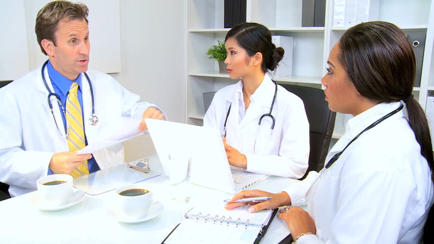 Meeting multi ethnic medical team in hospital boardroom