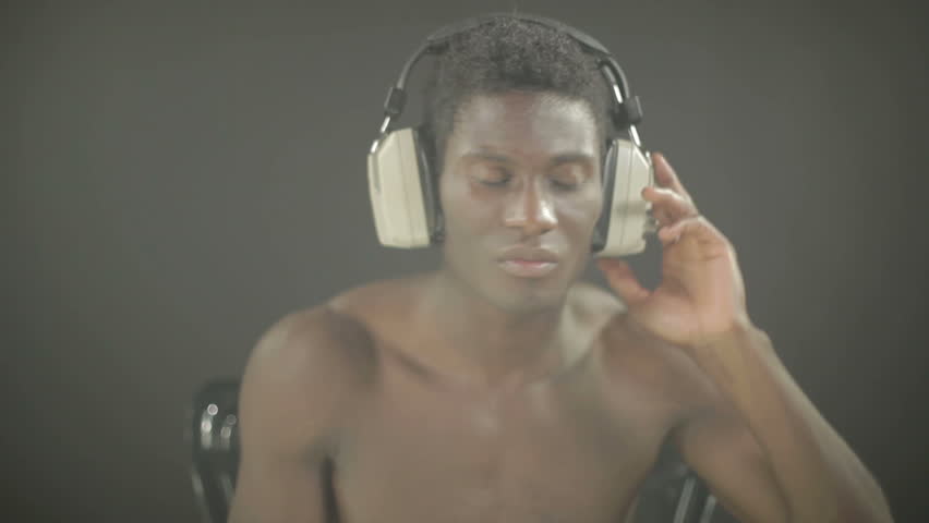 young african guy waving and dancing with a cool attitude with headphones