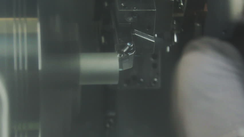 CNC machine is cutting metal part