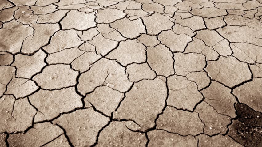 dried and cracked land over dramatic sky 