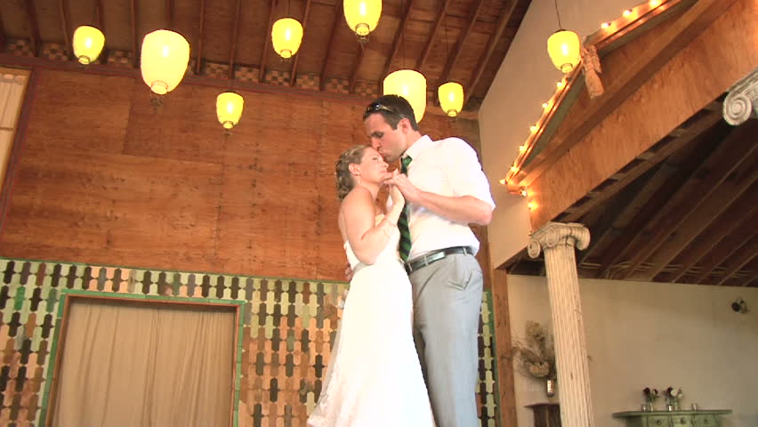 Model released bride and groom share their first dance together on their wedding day.
