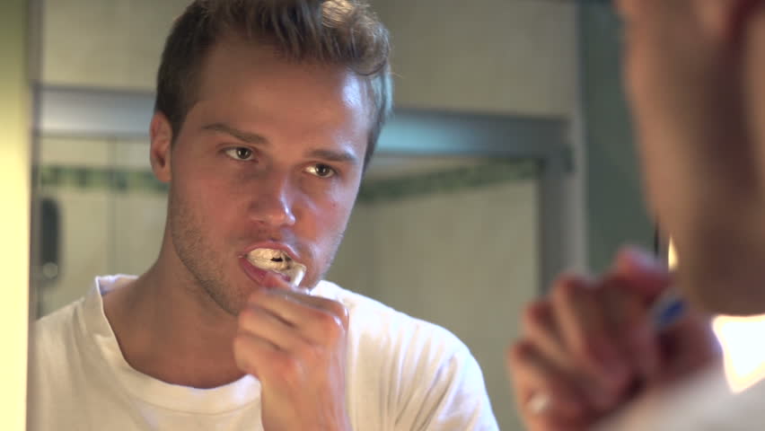 Man brushing his teeth in the morning
