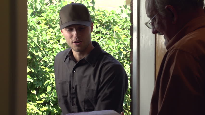 Delivery man delivering package to a home