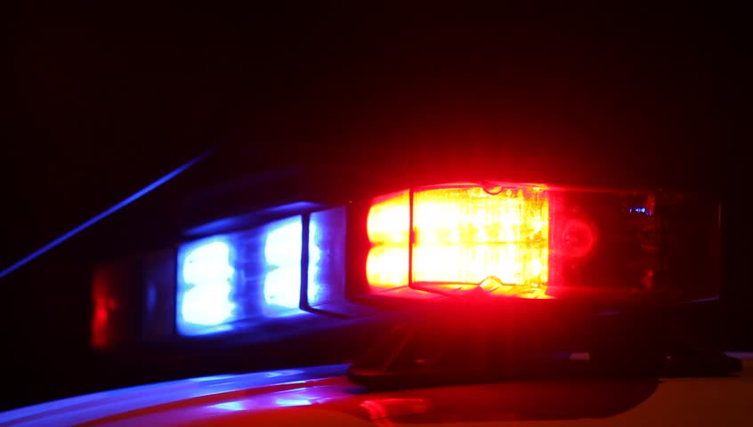 Red and blue emergency lights of police car. Night outdoor shot.
