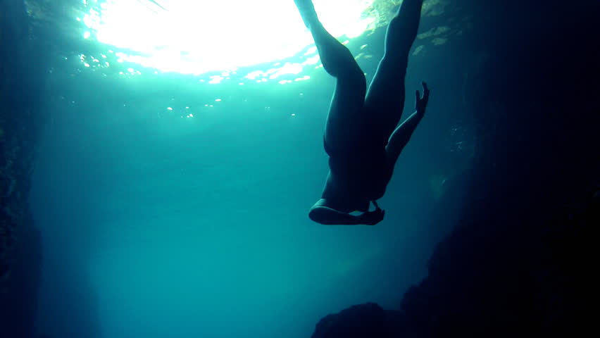 Slow diving
Diver slowing emerging to the surface. silhouette
