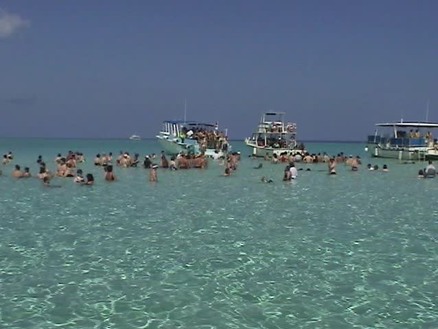 Video of tourists at Stingray City sandbar in Grand Cayman Islands. Waist deep clear warm water.