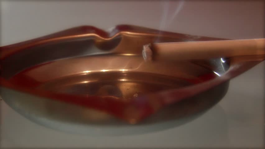 A burning cigarette in an ashtray -time lapse 3