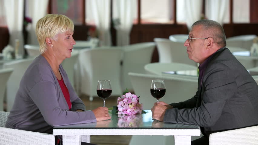 Husband and wife enjoying glass of red wine on a date