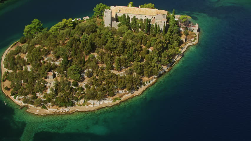 Aerial helicopter shoot of National park on island Mljet, Dubrovnik archipelago, Croatia. The oldest pine forest in Europe preserved and Monastery of Saint Mary on a small island in a big lake.