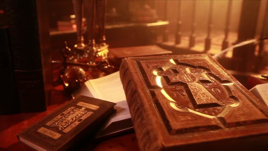 Move across ancient bibles over a modern bible and then to a bible on a tablet computer. Used to show how the bible has transformed over the centuries.