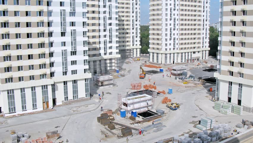 Builders work on building site of housing estate in sunny weather, time lapse
