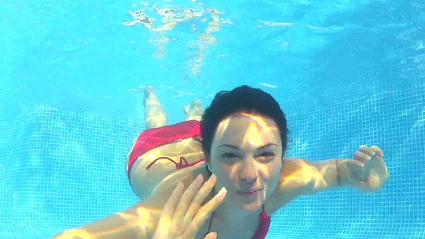 Brunette Woman Swimming Underwater In Slow Motion Stock
