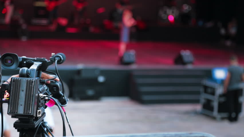 Video camera filming the rehearsal of dancers on stage