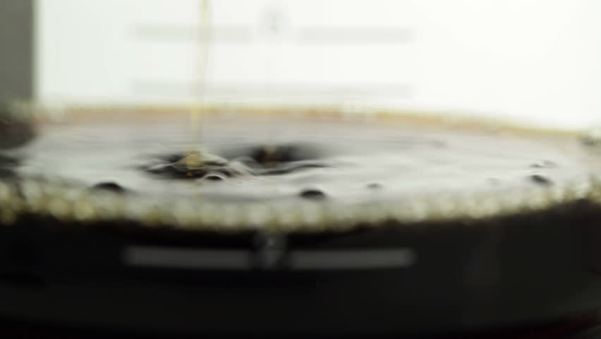 Coffeemaker, slow zoom from the drops to the scale of the coffee decanter