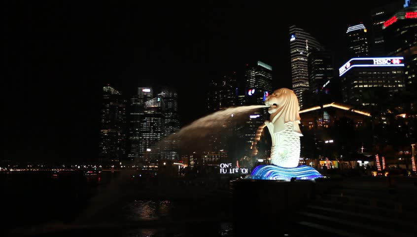 SINGAPORE - OCT 12: The Merlion fountain and Singapore skyline on October 12, 2012. Merlion is an imaginary creature with lion's head and a fish body and is often seen as a symbol of Singapore.
