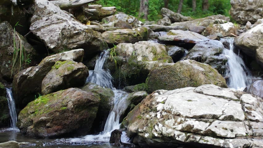Mountain river flowing down through the rocks.