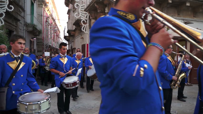 MARTINA FRANCA, ITALY - AUGUST 15: The marching band escorts the traditional Procession of Our Lady of the Assumption, followed by the Christian population parading through the city streets on August 15, 2012 in Martina Franca, Italy.