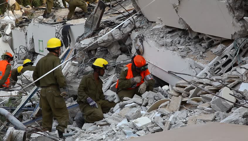 HOLON, ISRAEL - OCTOBER 21: Soldiers search for earthquake casualties digging through the rubble during earthquake drill in Holon, Israel, October 21, 2012