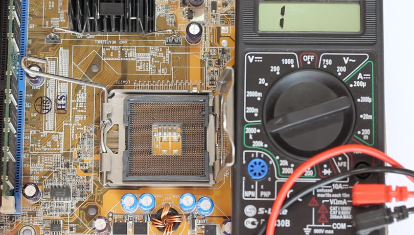 Man measures digital multimeter motherboard and processor.