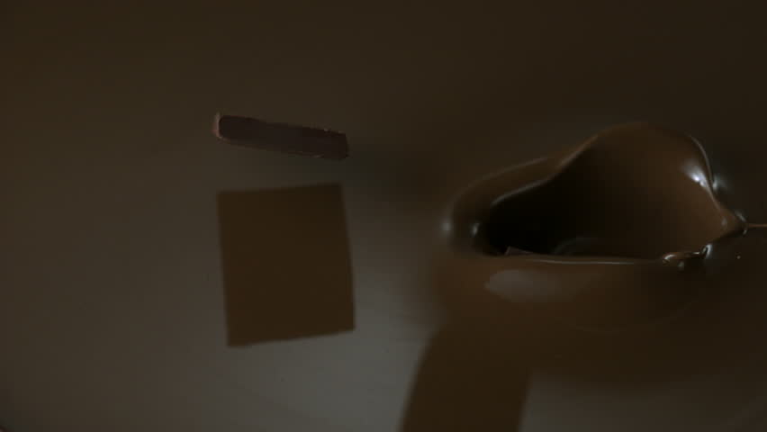 Chocolate falling in chocolate sauce shooting with high speed camera.