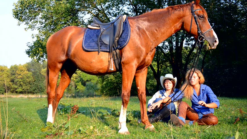 Two Beautiful Smiling Cowgirls with horse