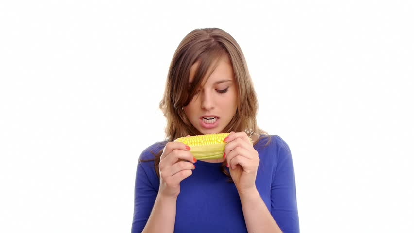 girl eats a tasty sweet corn with pleasure