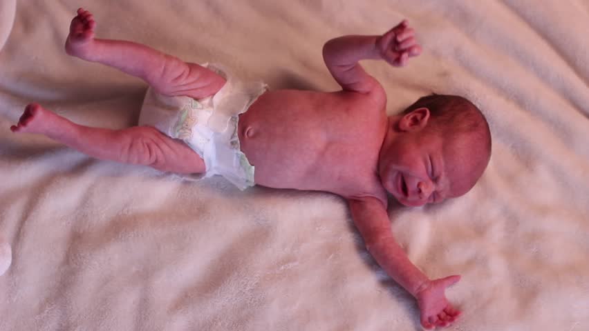 Baby sleeping crying in red and diaper