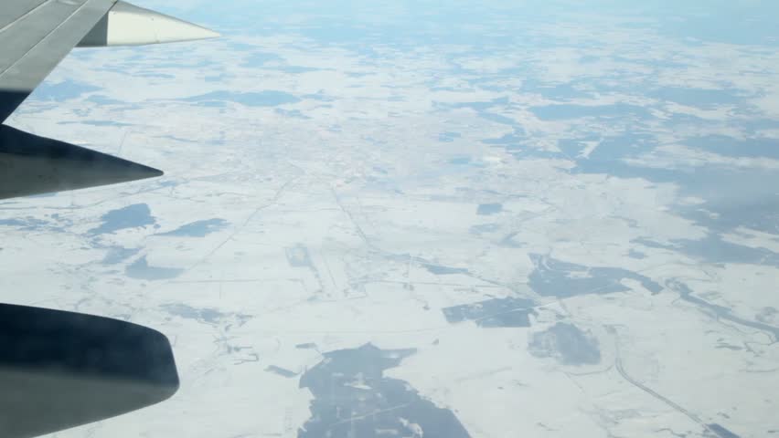 Earth with northern town, view from an aircraft window