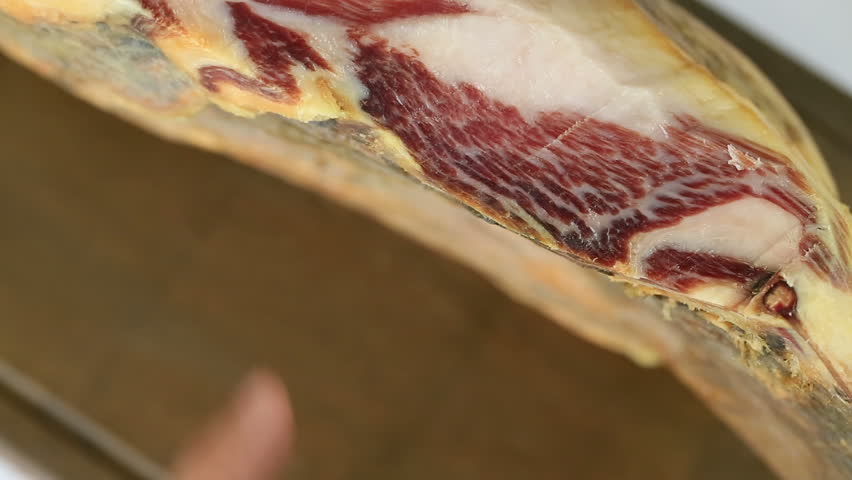 Cutting serrano ham slices