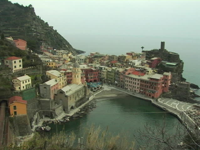 Beautiful Italian Riviera town of Vernazza with passing train.