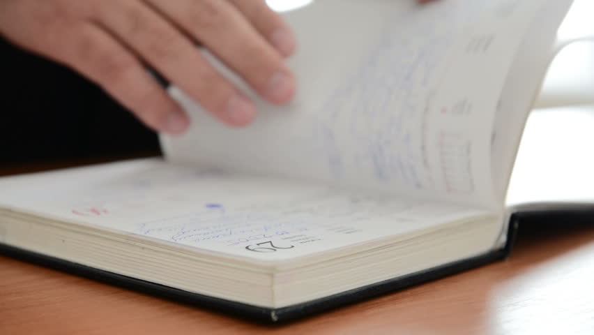 Man searches an important note in a notebook. Full HD