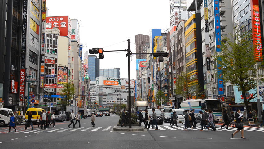 TOKYO, JAPAN - APRIL 12, 2012 Shinjuku Neon Sign Street, Shopping Area in Tokyo, Japan, Day Traffic Crowds