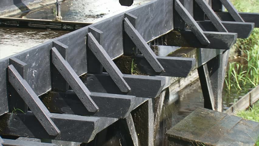Rotating water under waterway, wheel seen from backside.  De Middelste Molen  is a water-powered paper mill (1622) in Loenen, The Netherlands
