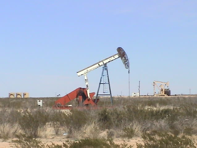 Video of a north Texas oil well pumping in the flat scrub desert.