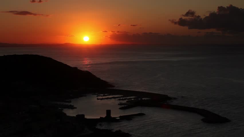 burning red sunset over seaport town time lapse