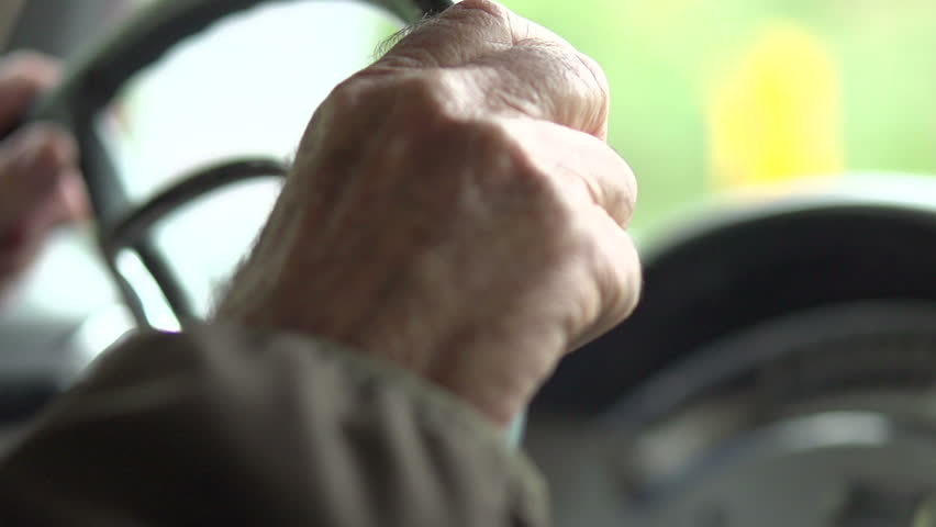 Aged hands Driving classic car. Slow motion. 