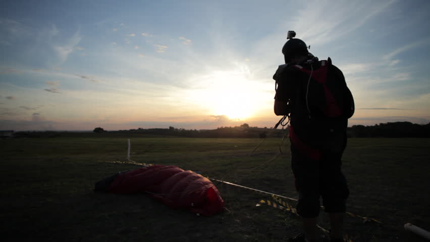 Skydiver landing at sunset