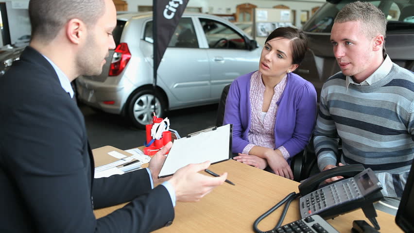Client signing a contract in a dealership