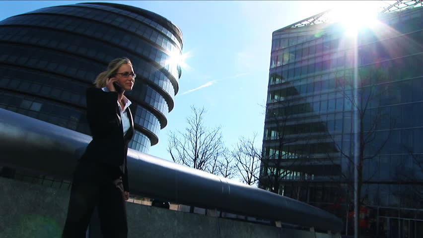 Attractive blond girl on mobile in city wide angle