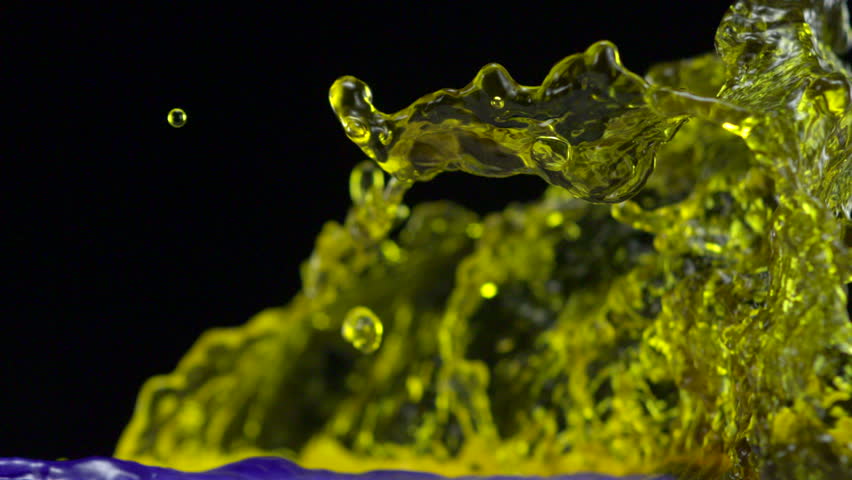 Colored water colliding and making splash shooting with high speed camera.