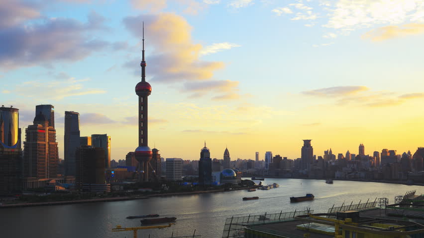 Shanghai skyline, panning timelapse. Shanghai skyscrapers and Huangpu river, China. On the left, Pudong with the Oriental Pearl Tower. On the right, The Bund (Puxi Waitan).
