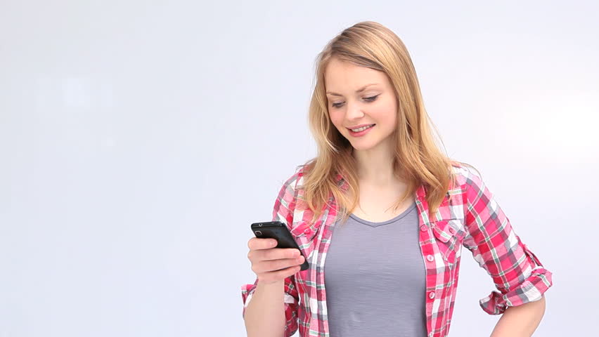 Young blond woman showing a smartphone screen against a white background