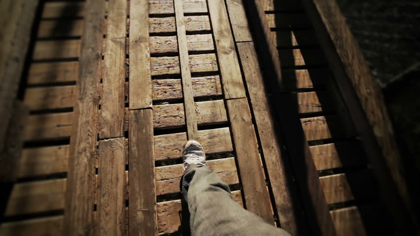 Man Walking on a footbridge
