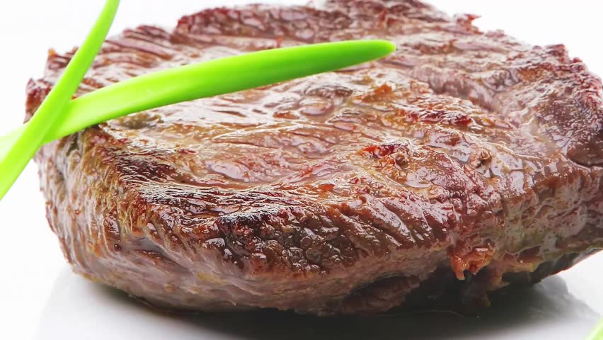 meat food : roasted fillet mignon on white plate with green sprouts isolated over white background
