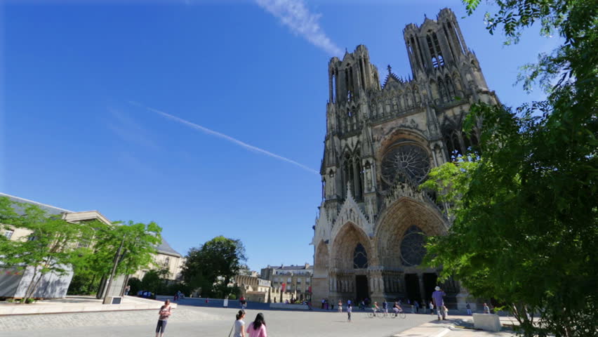 REIMS,FRANCE-JULY 24, 2012: Tourists by the impressive Notre-Dame Cathedral,the wonderful Roman Catholic church where the kings of France were once crowned: it celebrated its 800th anniversary in 2011