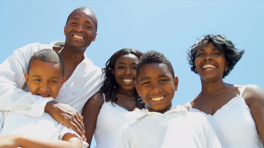 Diverse sons and daughter laughing and chilling with parents on video postcard