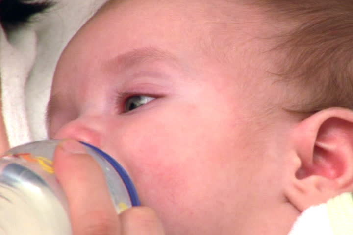 Little baby boy eating from a bottle
