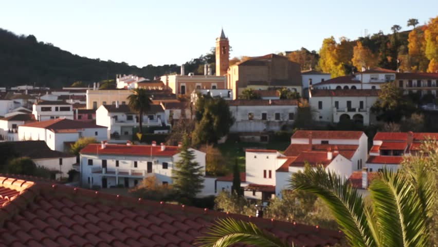 Andalusian village. Tranquil Andalusian white village with mountains, trees and the church, in the background