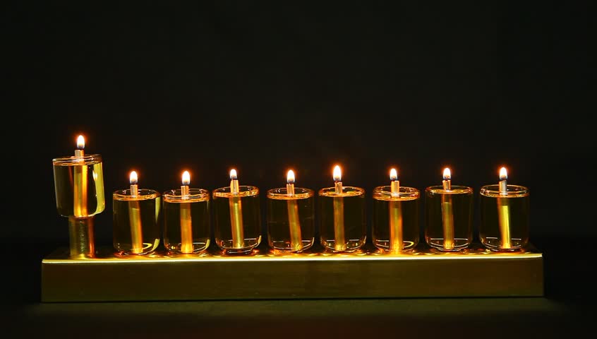 Flames extinguished in Hanukia made of olive oil lanterns
