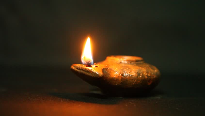 Olive oil clay ancient lantern lamp - flame in motion
